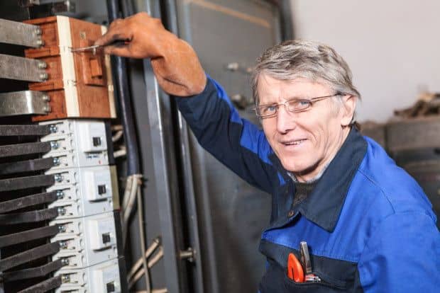 COST-electrician-working-on-circuit-breaker